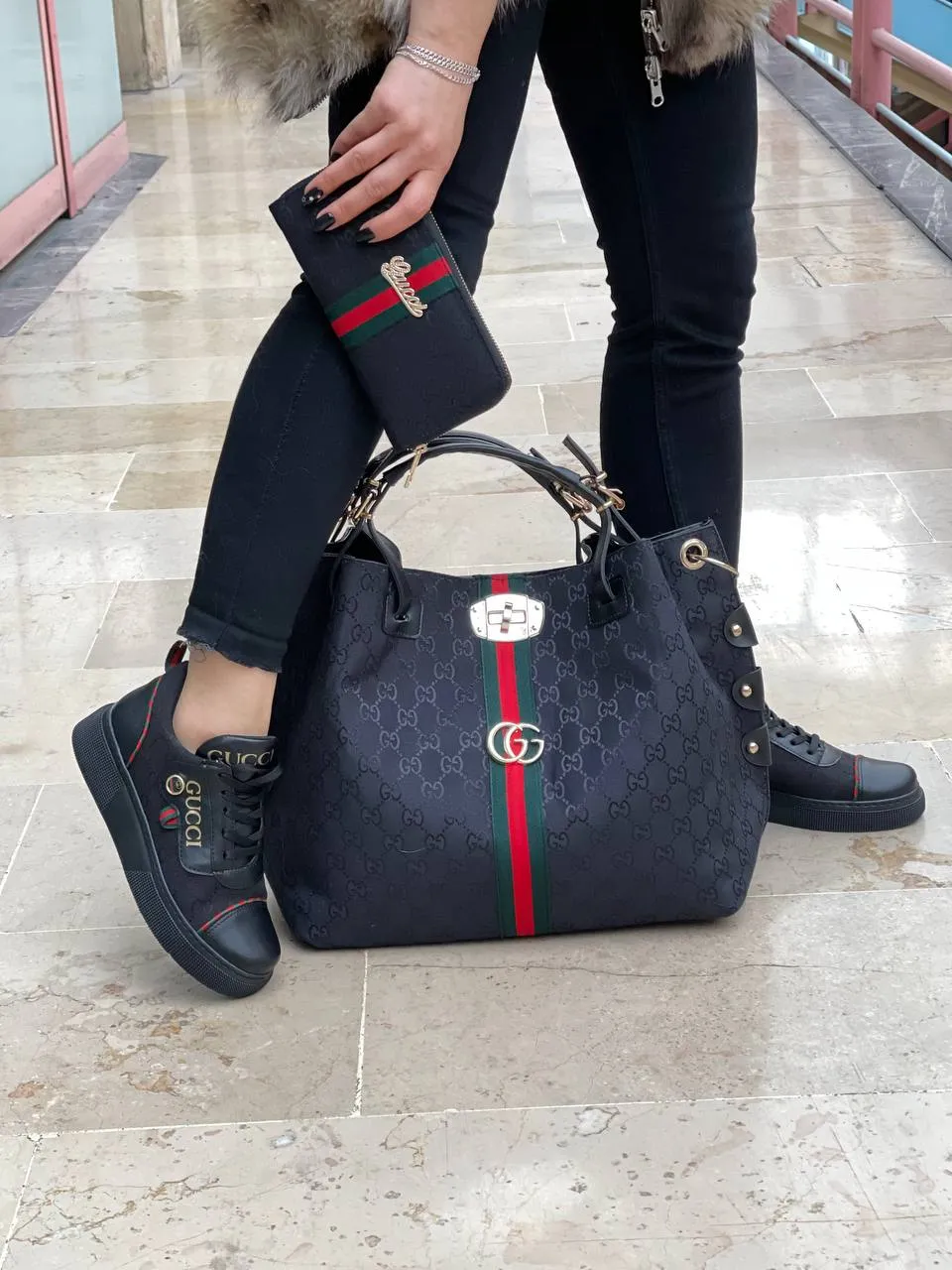 Black sneaker bag set with GG next to it